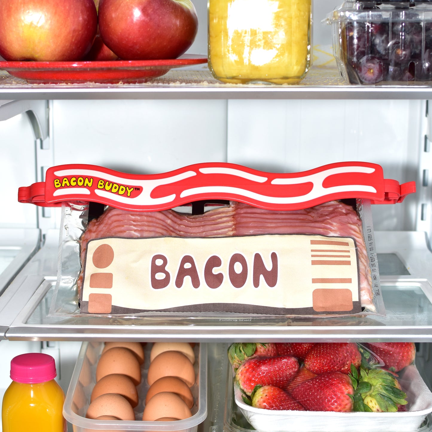 bacon buddy clip - bacon storage container, bacon keeper for fridge, air tight food storage container, chip clip for your bacon, kitchen organization, cooking accessories, fun food clip. Shown in use, clipped on a pack of bacon in a fridge keeping bacon fresh and organized